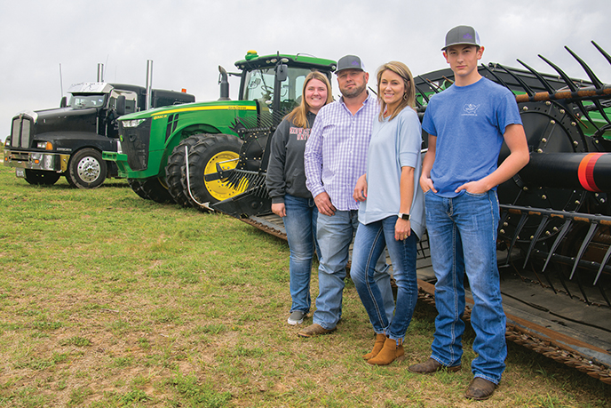 Custom harvesting is a family affair for the Gregorys, from left to right: Hadley, Jeff, Shana, and Hayden. Photo by: Sheryl Smith-Rodgers